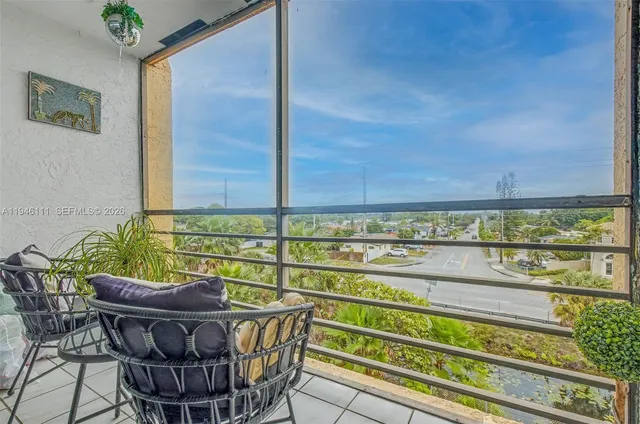 a view of a chairs and table in the balcony