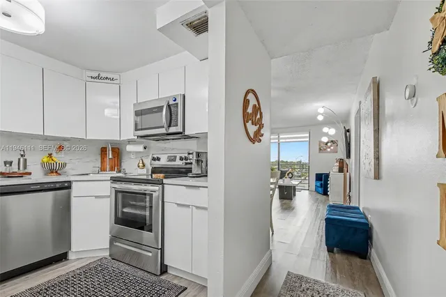 a kitchen with a refrigerator and a stove top oven