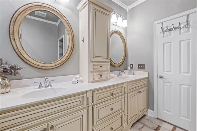 a bathroom with a granite countertop double vanity sink and a mirror