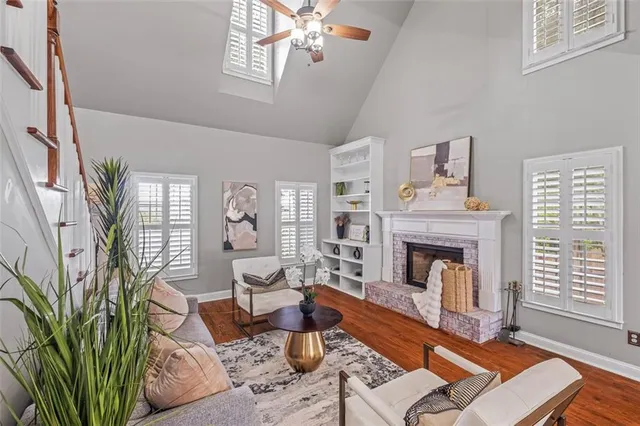 a living room with furniture fireplace and wooden floor