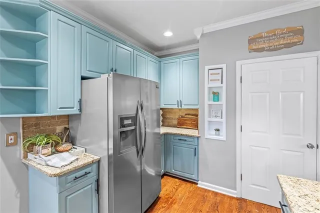 a kitchen with stainless steel appliances granite countertop a refrigerator and a stove
