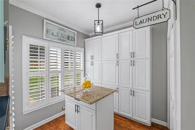 a view of a kitchen with a sink and cabinets