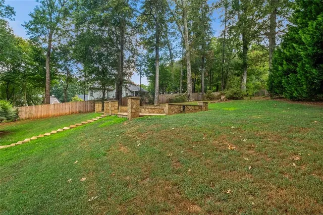 a view of a backyard with a garden and trees
