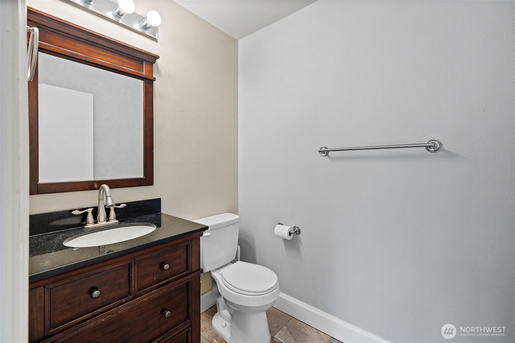 5021 Ripley Lane North, Unit 212 Renton, WA 98056 - Photo 12 of 34 a bathroom with a granite countertop toilet sink and mirror