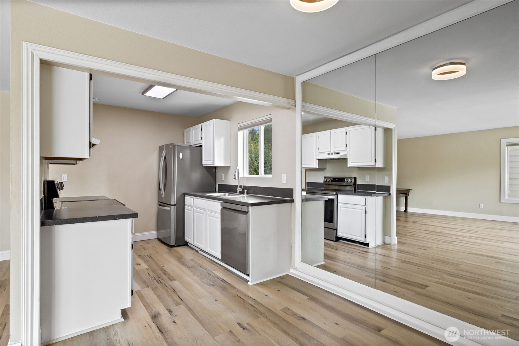 5021 Ripley Lane North, Unit 212 Renton, WA 98056 - Photo 8 of 34 a kitchen with granite countertop a refrigerator stove top oven and sink