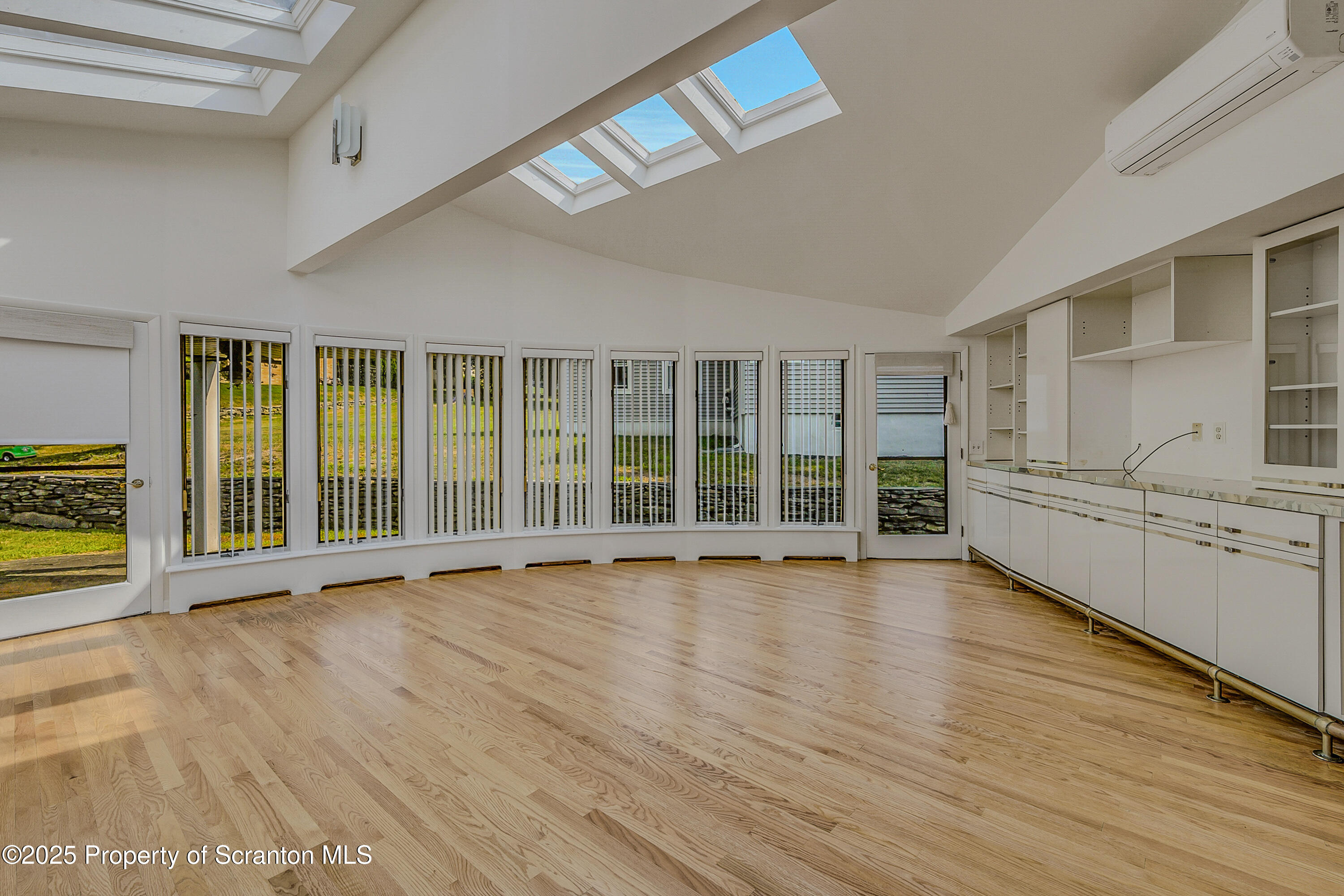 101 Old Post Road Clarks Summit, PA 18411 - Photo 14 of 48 a view of an empty room with a window and wooden floor