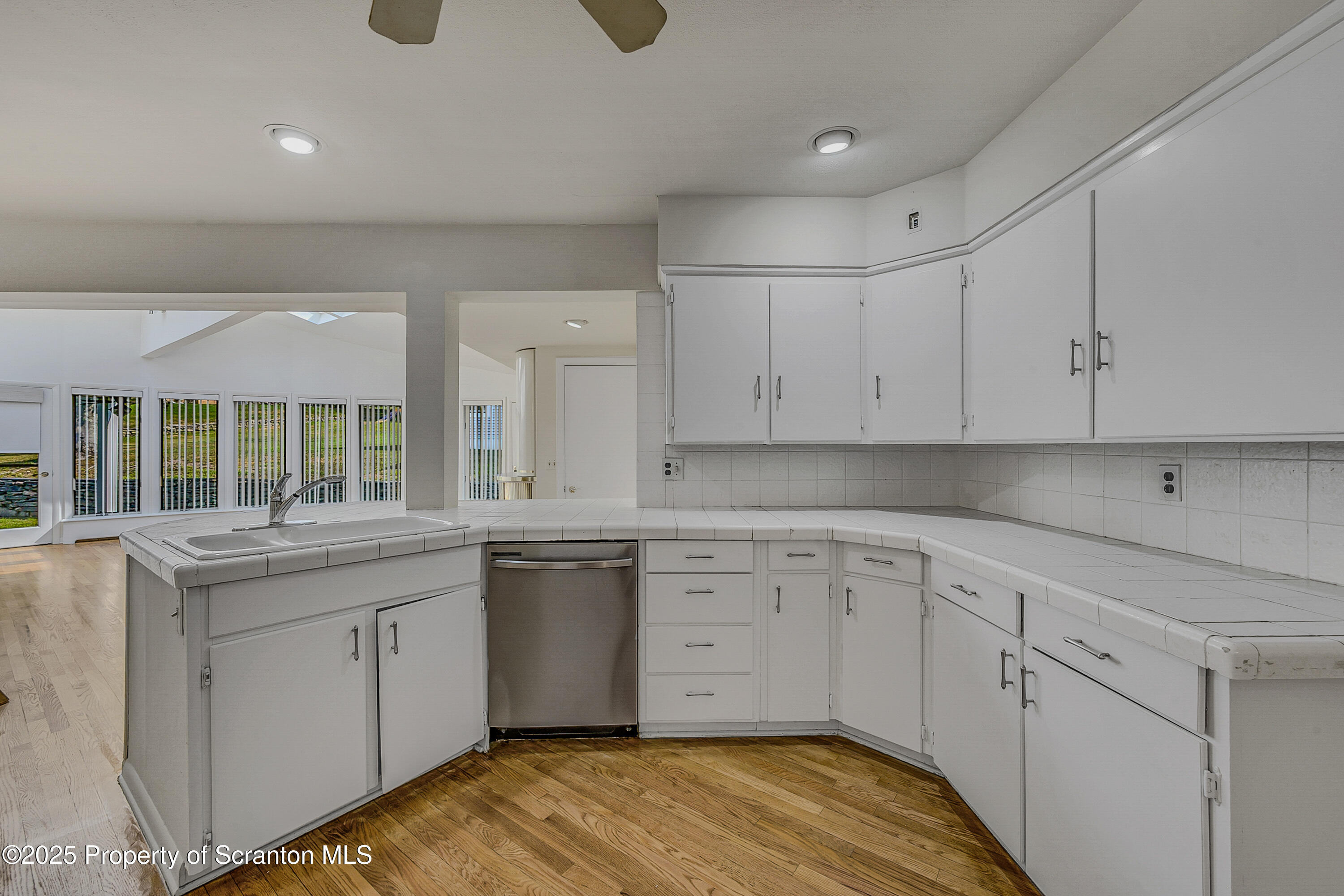 101 Old Post Road Clarks Summit, PA 18411 - Photo 19 of 48 a kitchen with granite countertop white cabinets and white appliances