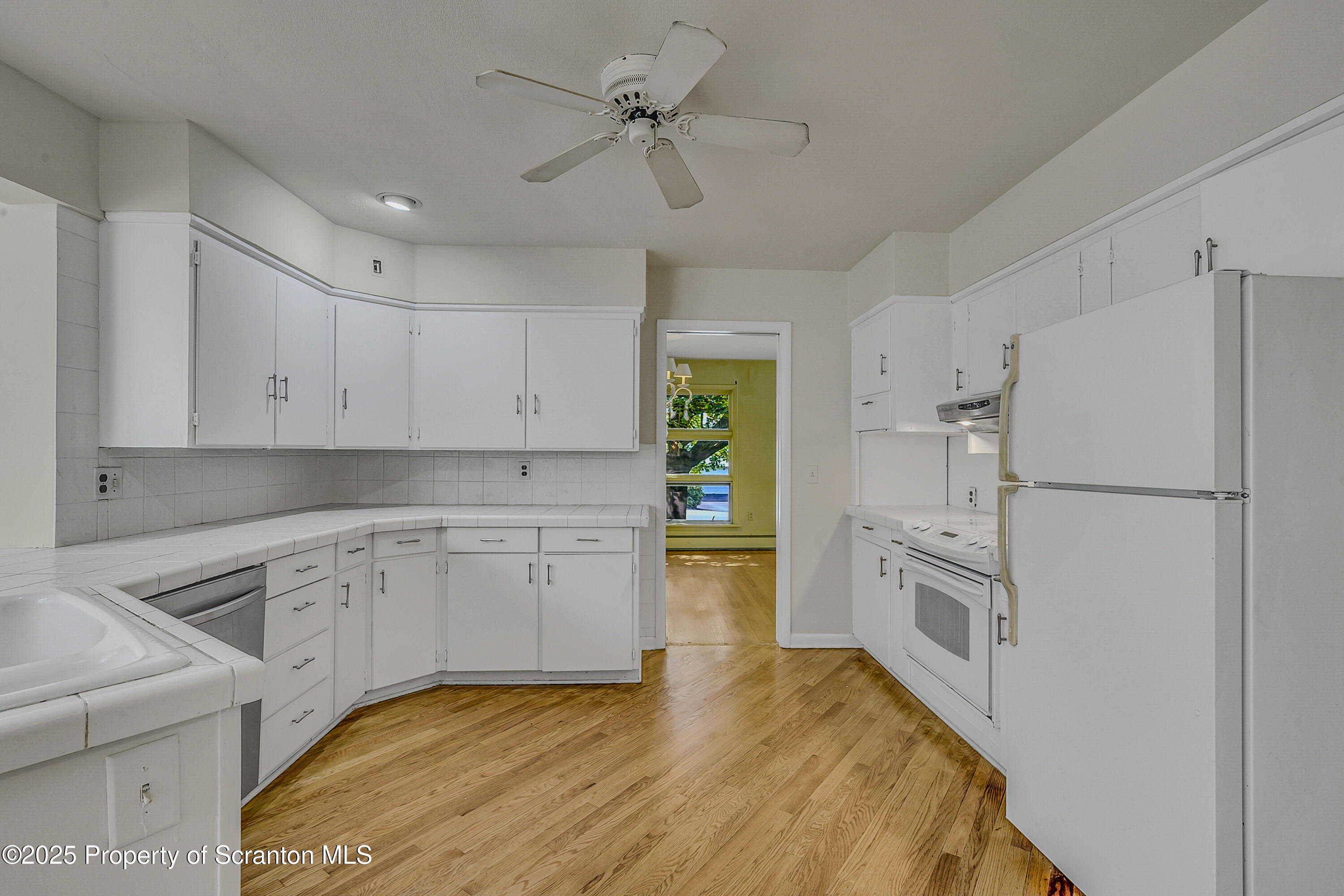 101 Old Post Road Clarks Summit, PA 18411 - Photo 20 of 48 a kitchen with white cabinets and white appliances