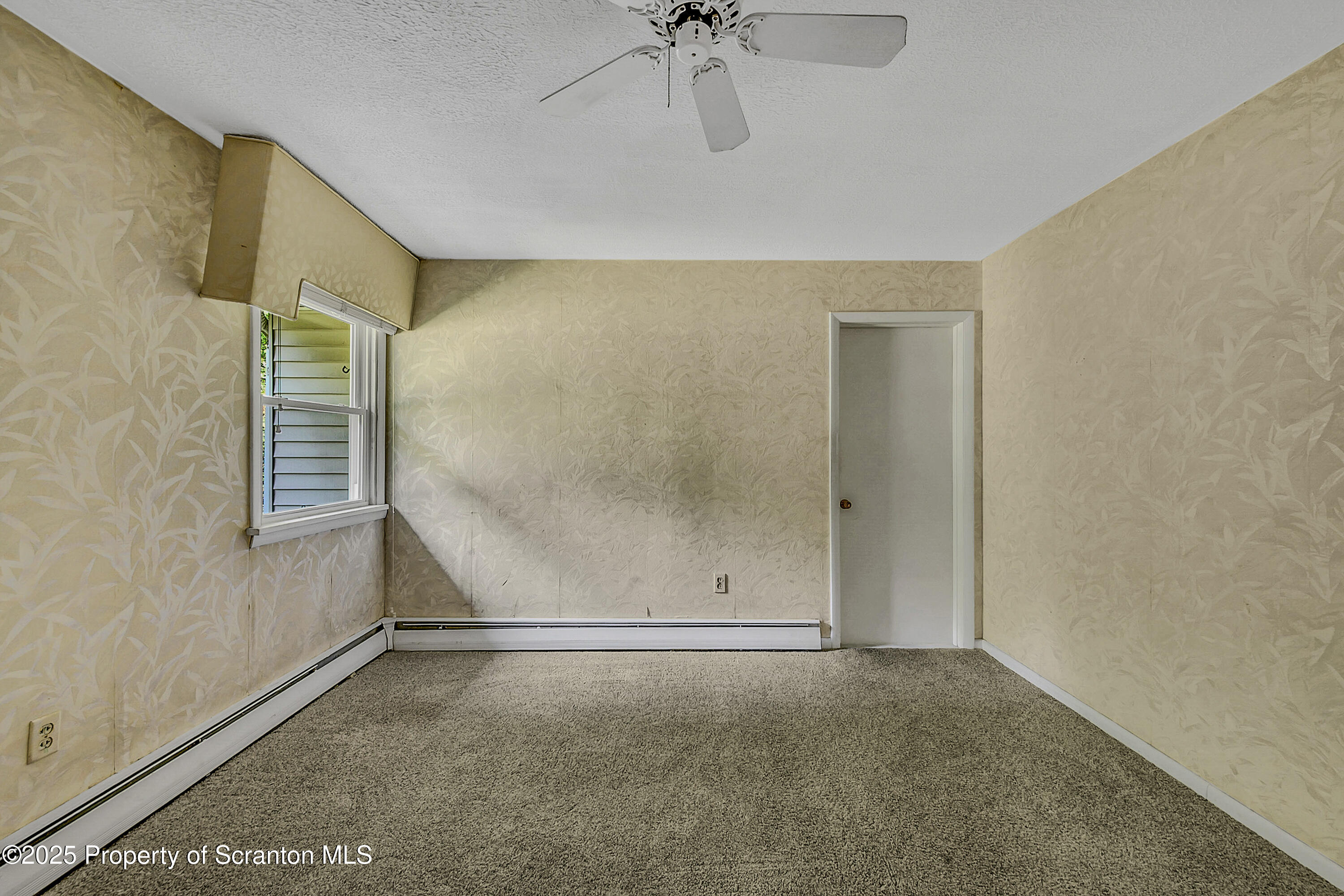 101 Old Post Road Clarks Summit, PA 18411 - Photo 24 of 48 an empty room with a ceiling fan and windows