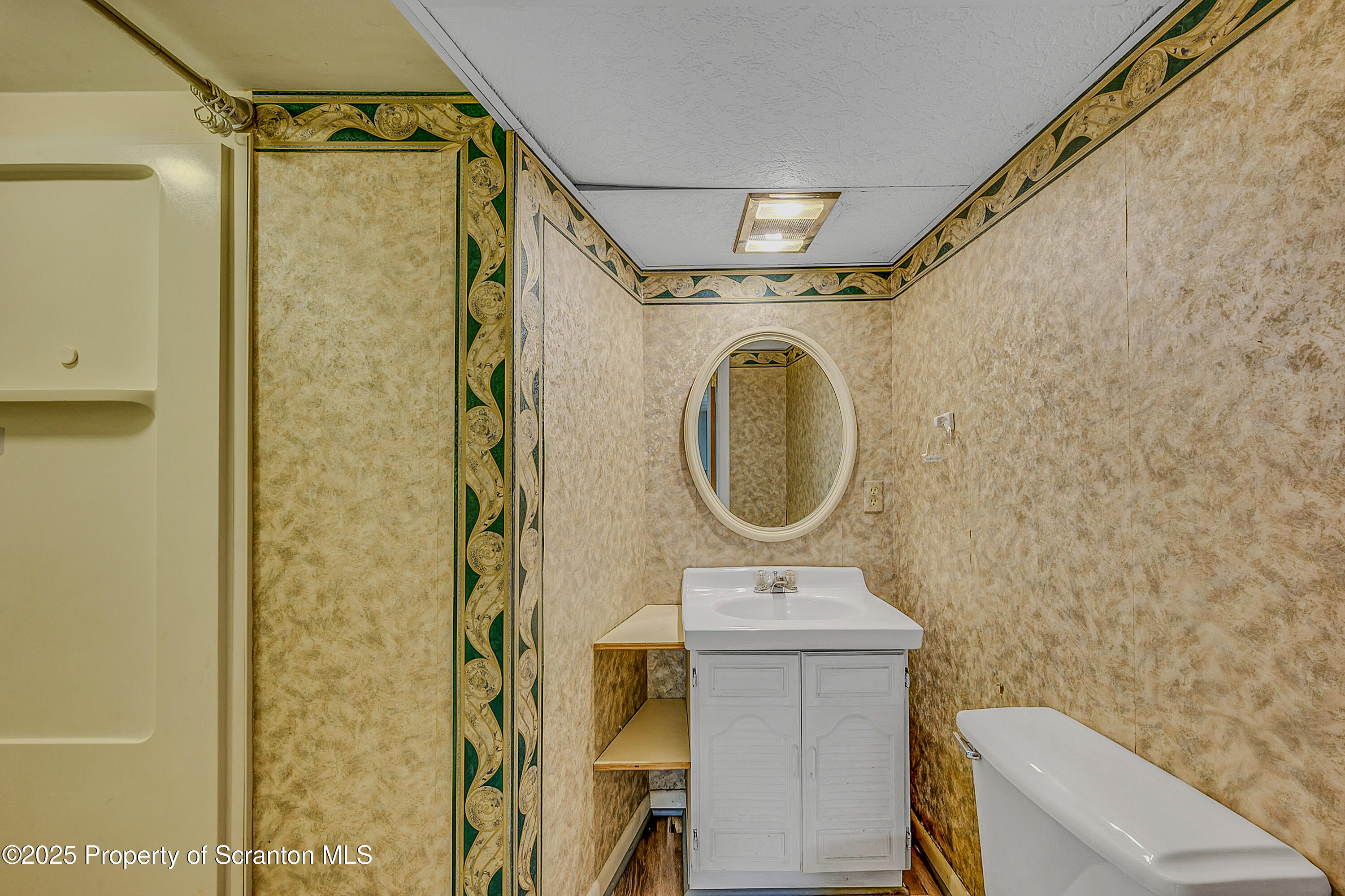 101 Old Post Road Clarks Summit, PA 18411 - Photo 38 of 48 a bathroom with a sink a mirror a toilet and a shower
