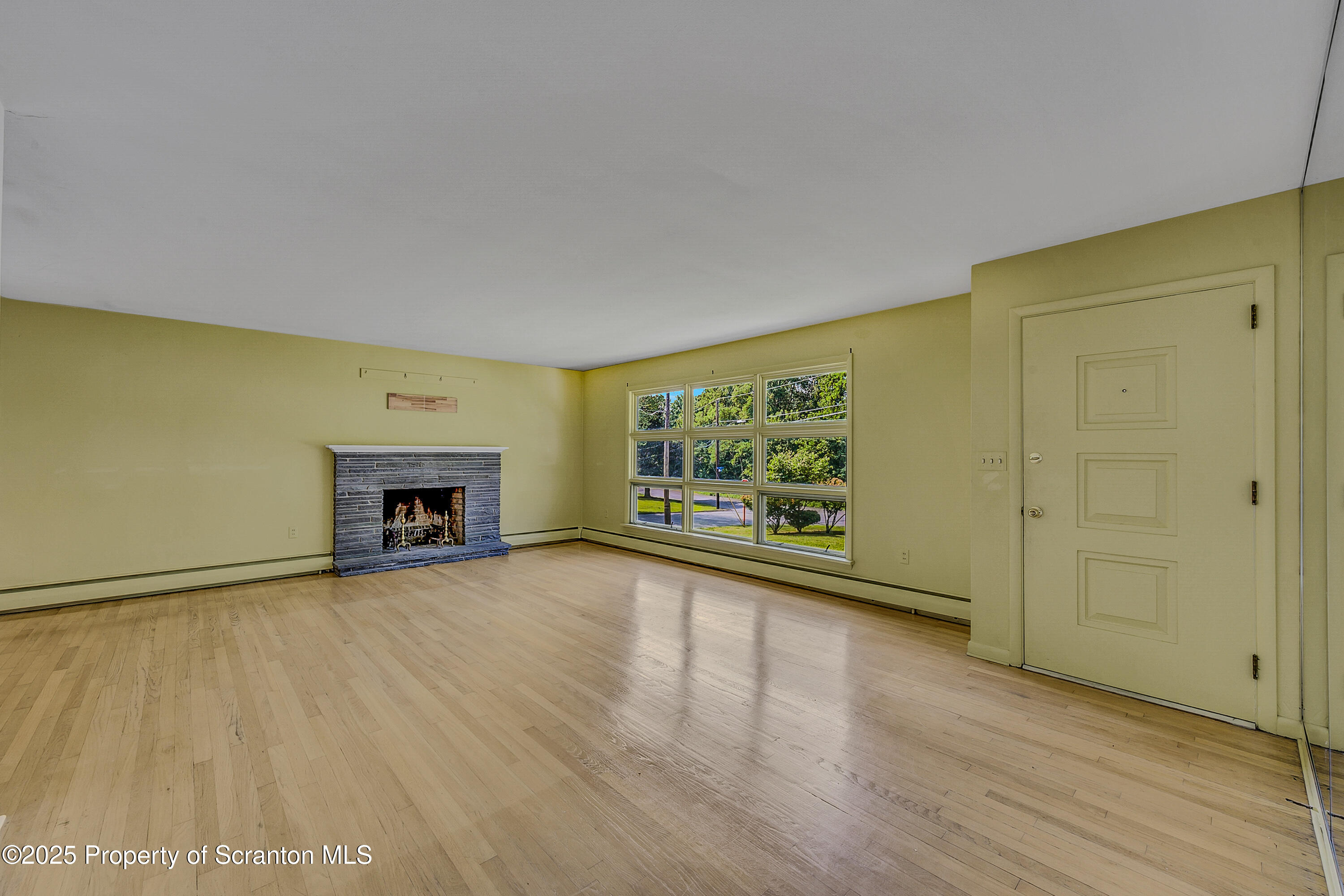 101 Old Post Road Clarks Summit, PA 18411 - Photo 8 of 48 a view of an empty room with a fireplace and a window