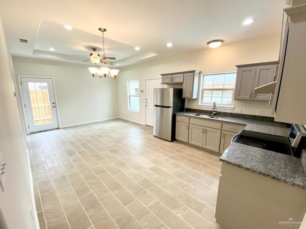 5601 Nightingale Avenue, Unit 2 McAllen, TX 78504 - Photo 5 of 12 Kitchen with freestanding refrigerator, range with electric cooktop, a raised ceiling, ceiling fan, and recessed lighting