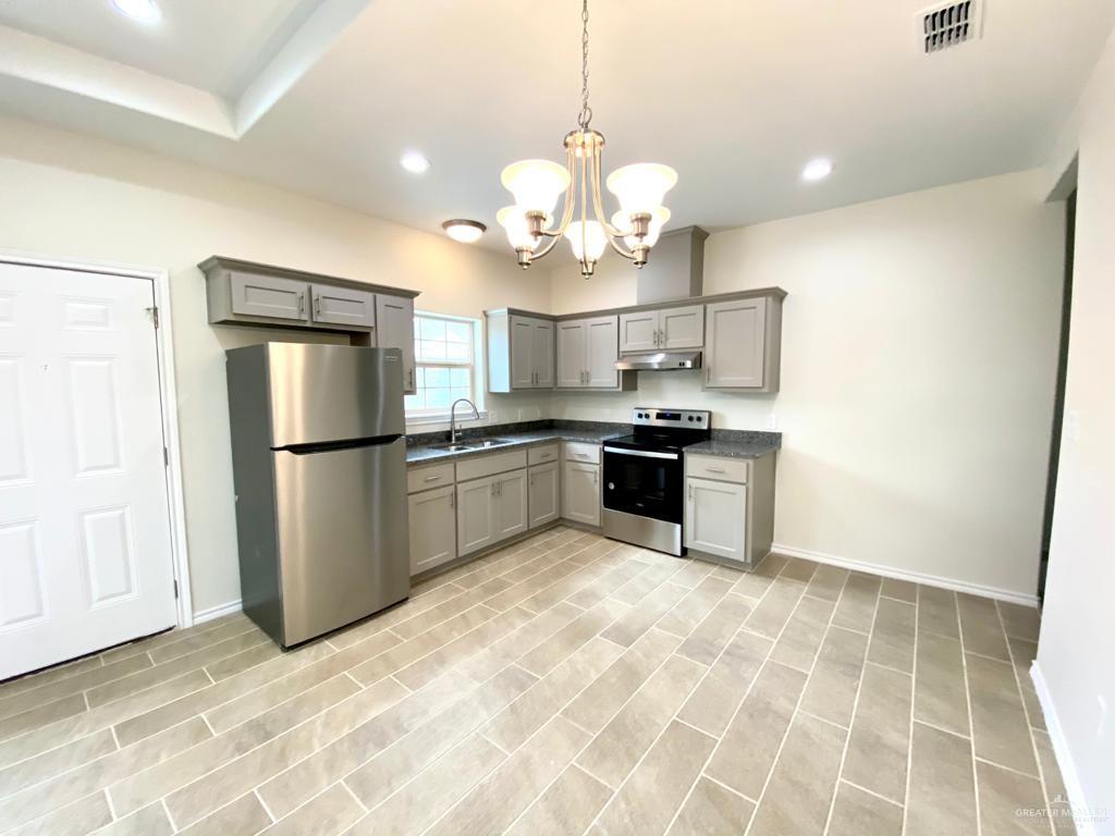 5601 Nightingale Avenue, Unit 2 McAllen, TX 78504 - Photo 6 of 12 Kitchen with stainless steel appliances, gray cabinetry, under cabinet range hood, dark countertops, and recessed lighting