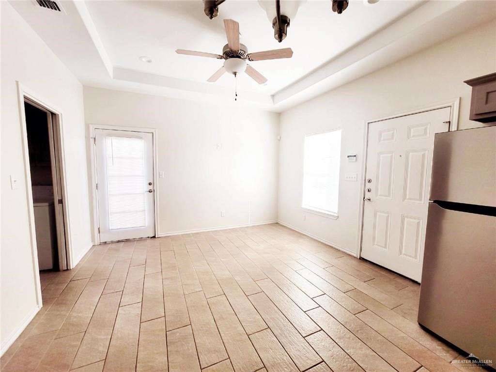 5601 Nightingale Avenue, Unit 2 McAllen, TX 78504 - Photo 8 of 12 Entrance foyer with a tray ceiling, plenty of natural light, a ceiling fan, and light wood-style flooring