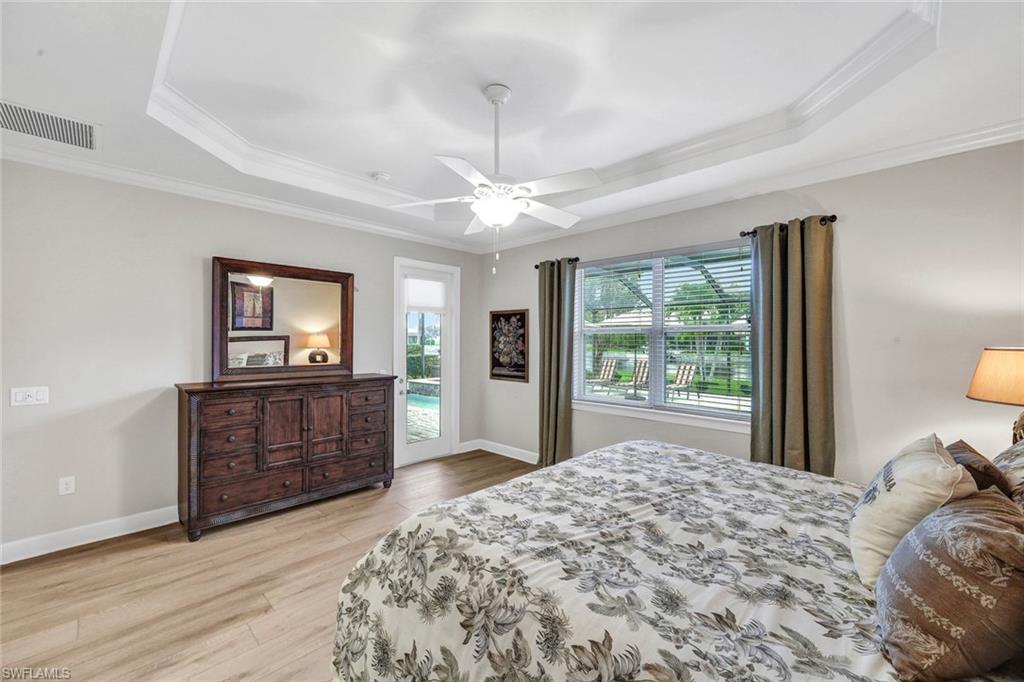 9111 Graphite Circle Naples, FL 34120 - Photo 13 of 33 a bedroom with a bed and a dresser