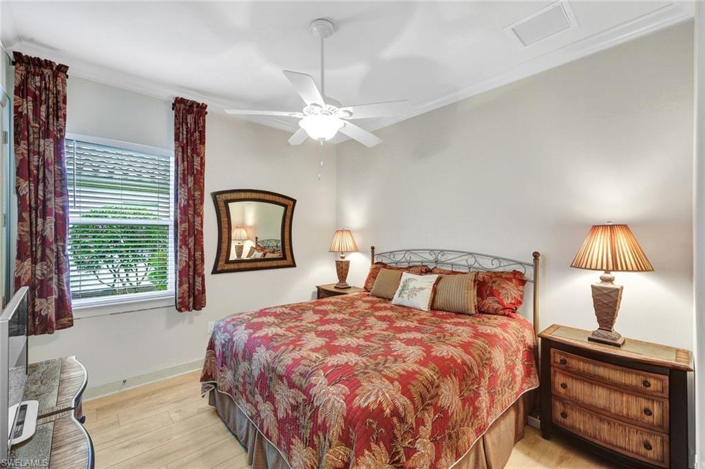 9111 Graphite Circle Naples, FL 34120 - Photo 16 of 33 a bedroom with a bed and a window