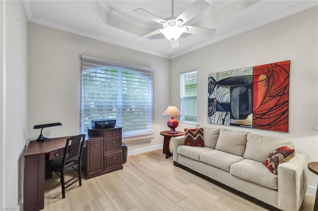 9111 Graphite Circle Naples, FL 34120 - Photo 19 of 33 a living room with furniture and a flat screen tv
