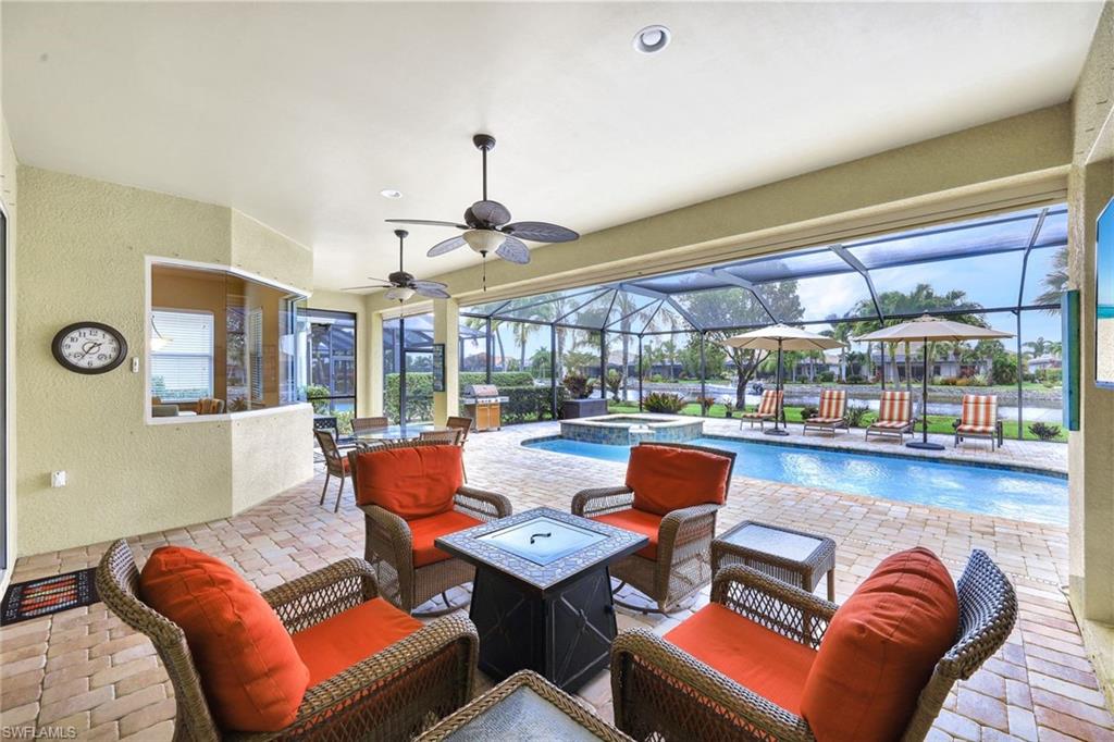 9111 Graphite Circle Naples, FL 34120 - Photo 21 of 33 a living room with furniture and a floor to ceiling window