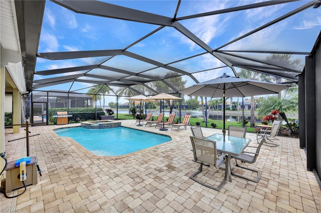 9111 Graphite Circle Naples, FL 34120 - Photo 24 of 33 a view of a swimming pool with a patio