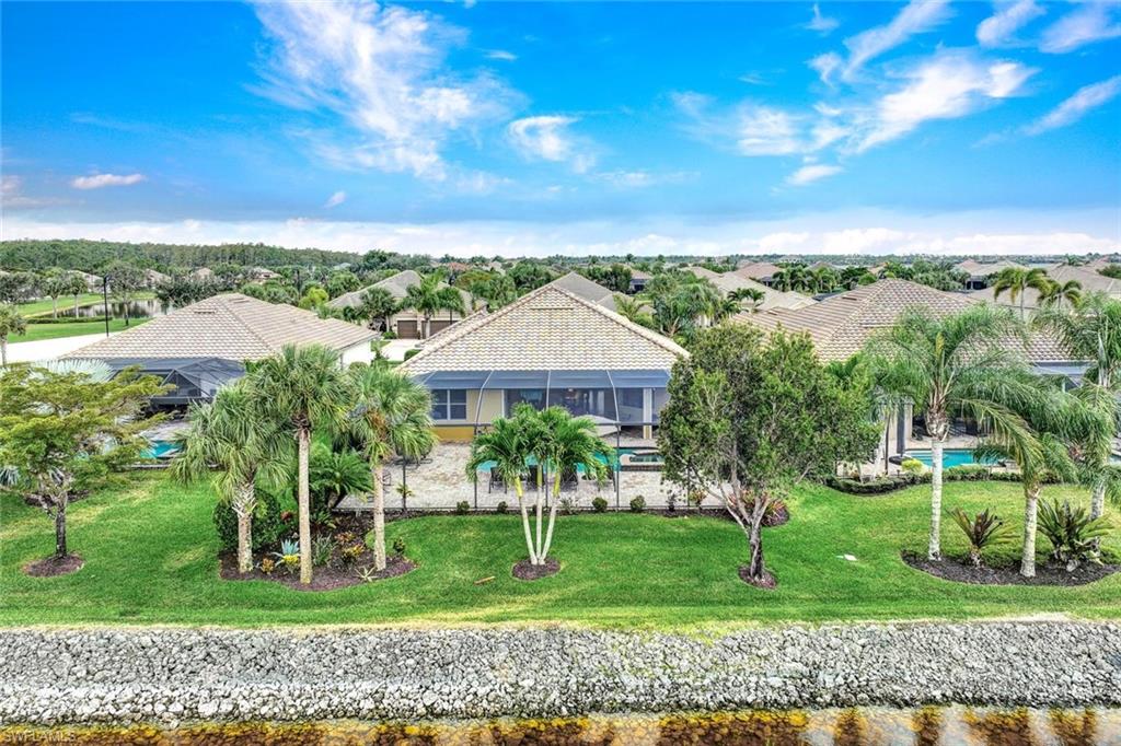 9111 Graphite Circle Naples, FL 34120 - Photo 25 of 33 a front view of a house with garden