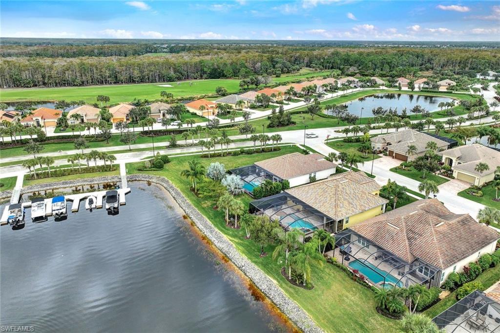 9111 Graphite Circle Naples, FL 34120 - Photo 27 of 33 an aerial view of a house with a garden and lake view