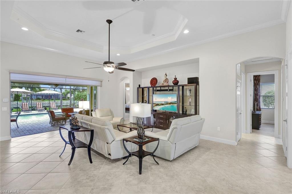 9111 Graphite Circle Naples, FL 34120 - Photo 10 of 33 a dining room with furniture a chandelier and a rug