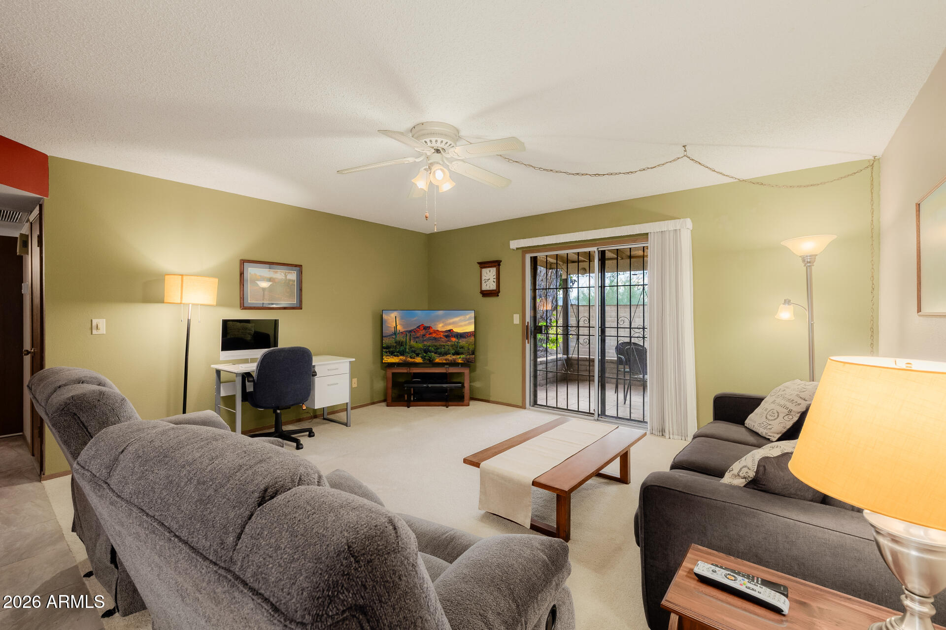 131 North Higley Road, Unit 16 Mesa, AZ 85205 - Photo 1 of 17 a living room with furniture ceiling fan and a window