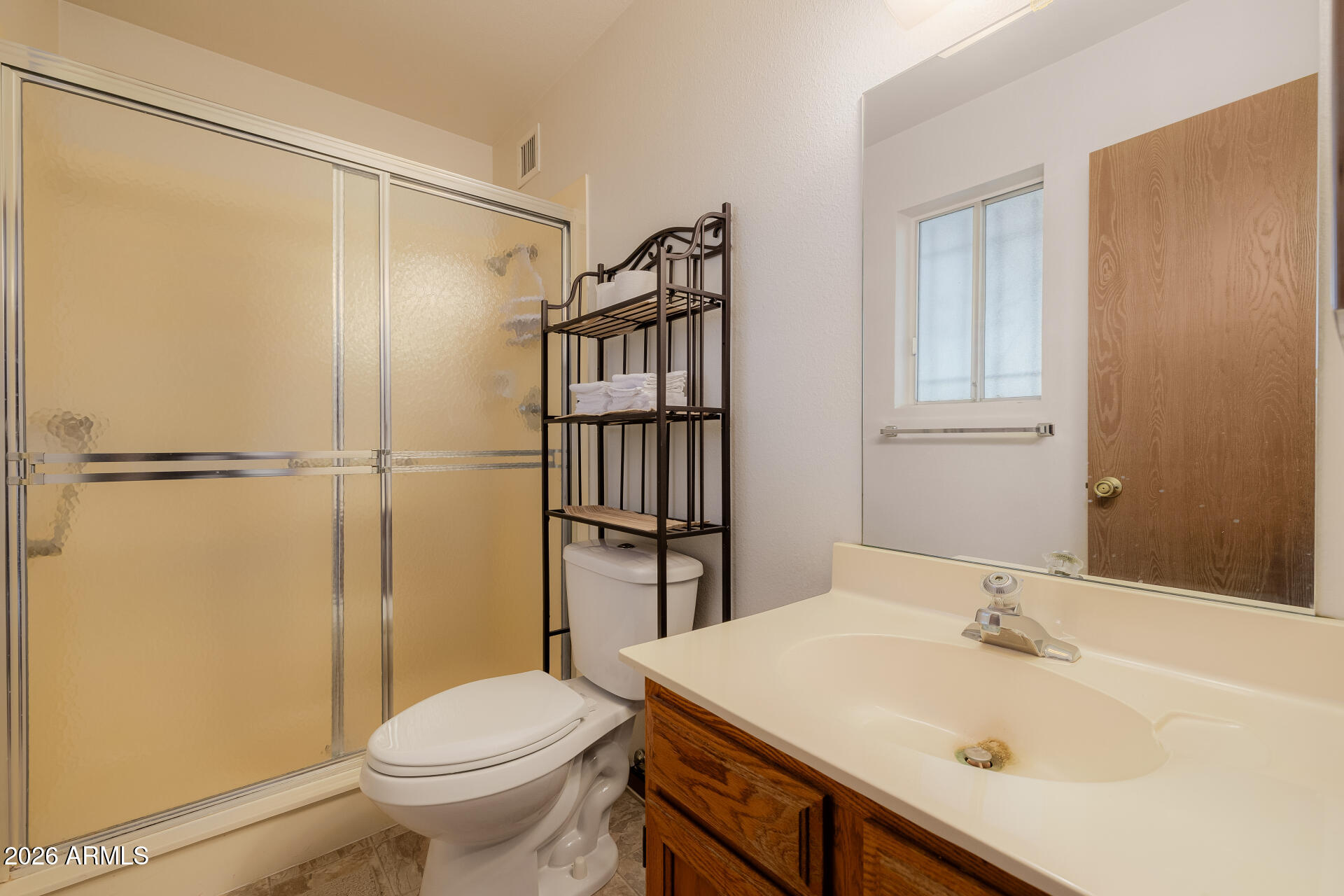 131 North Higley Road, Unit 16 Mesa, AZ 85205 - Photo 9 of 17 a bathroom with a sink toilet and shower