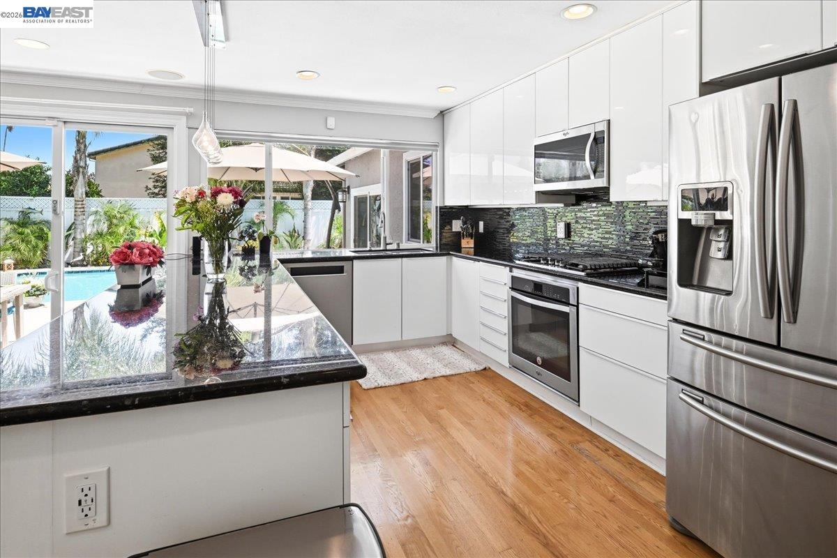 2861 Millbridge Place San Ramon, CA 94583 - Photo 15 of 58 a kitchen with stainless steel appliances granite countertop a refrigerator a stove and a sink