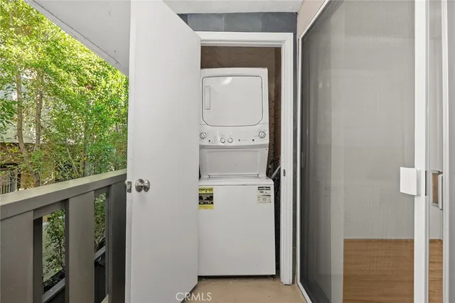 a view of walk in closet with wooden floor