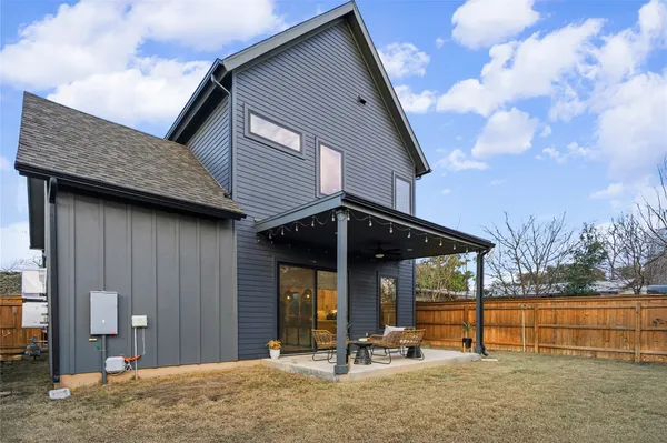 a view of a house with backyard porch and sitting area