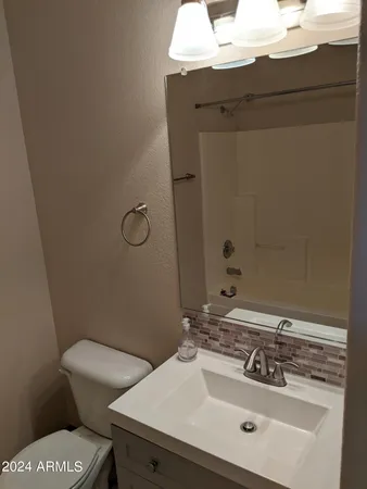 a bathroom with a sink toilet and vanity