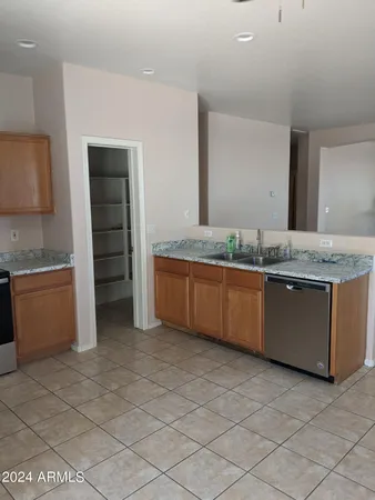 a kitchen with granite countertop a sink and cabinets