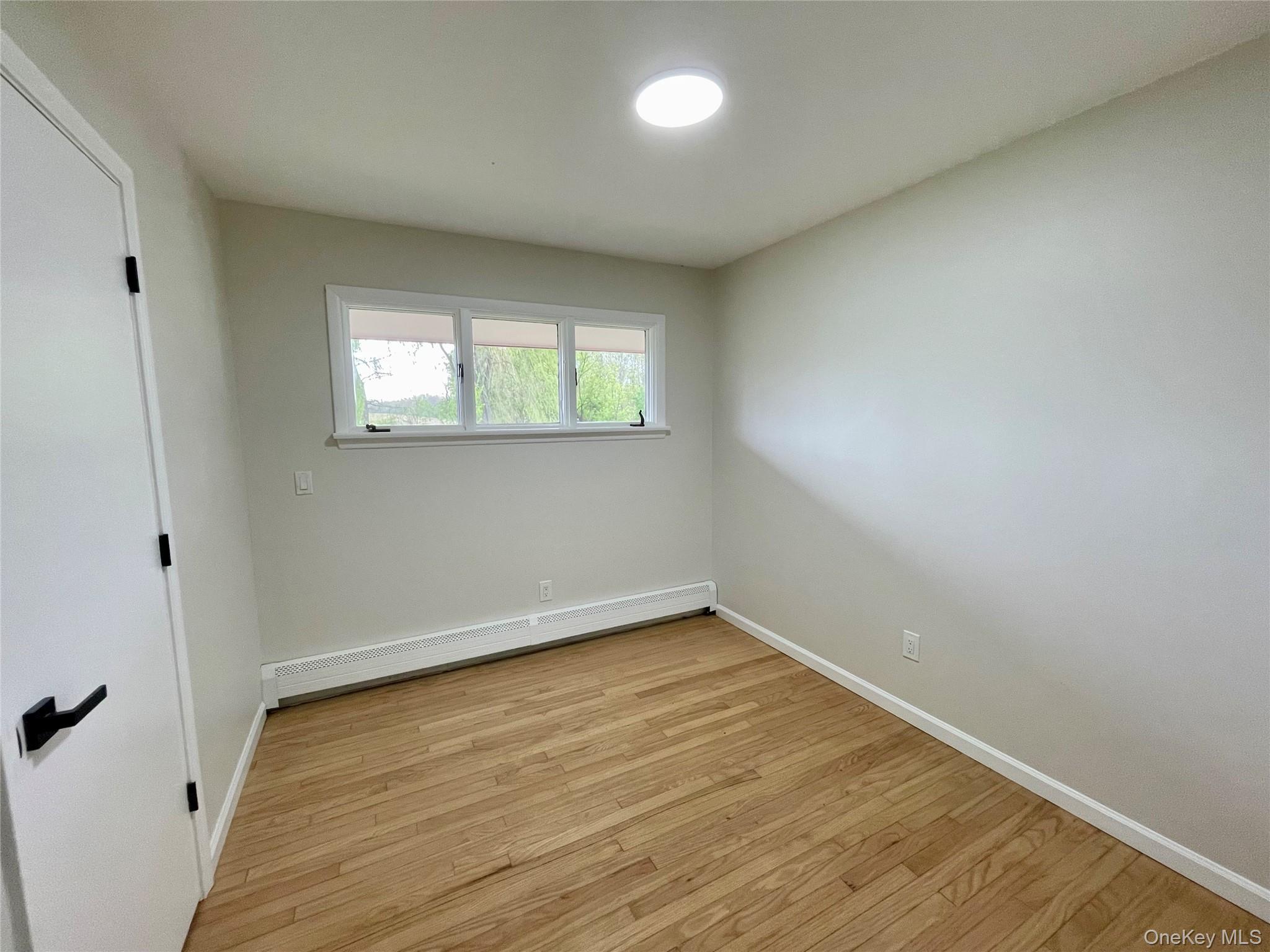 70 County Rte 17 Pine Bush, NY 12566 - Photo 25 of 36 wooden floor in an empty room with a window