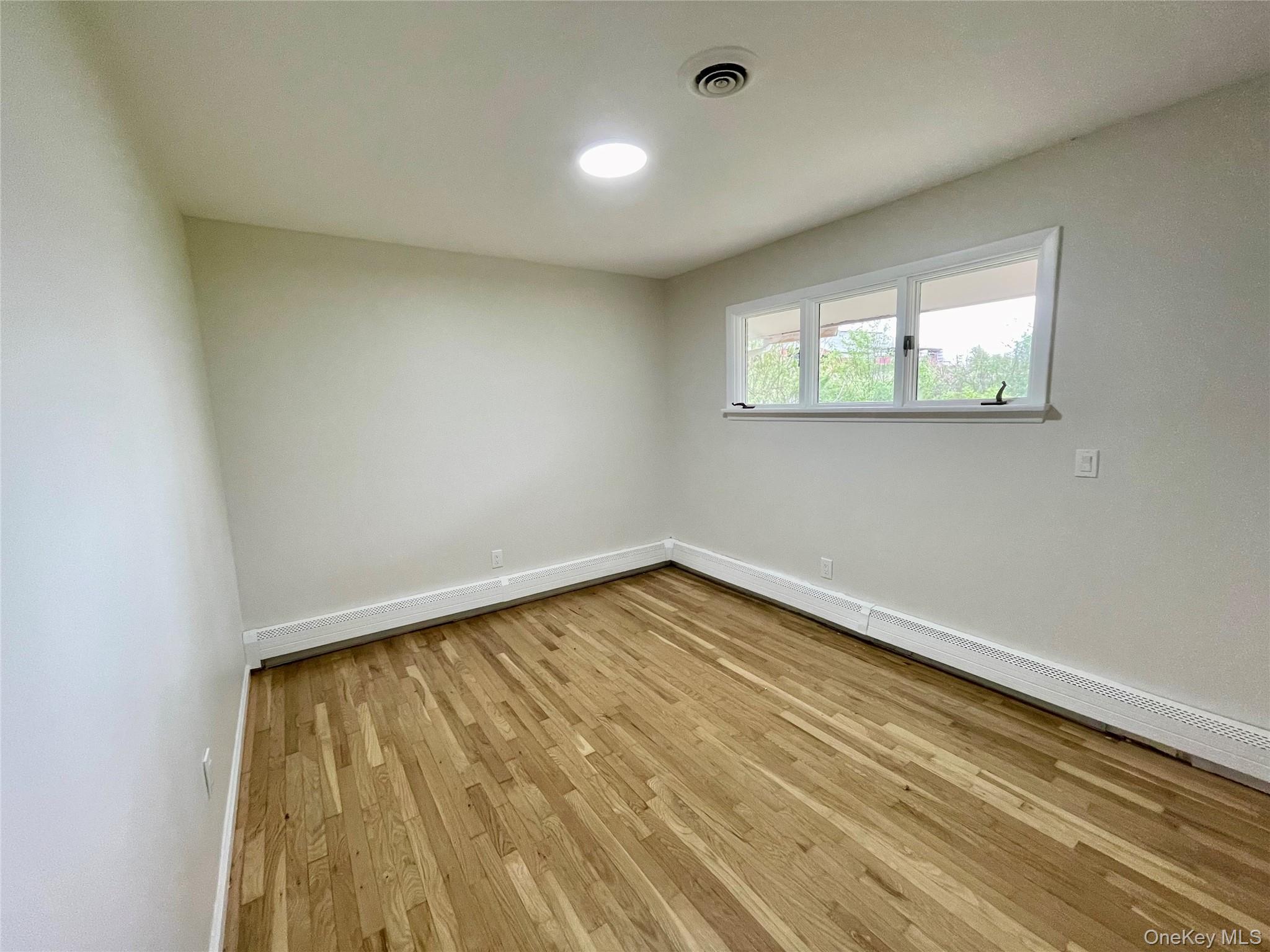 70 County Rte 17 Pine Bush, NY 12566 - Photo 27 of 36 a view of empty room with wooden floor and fan