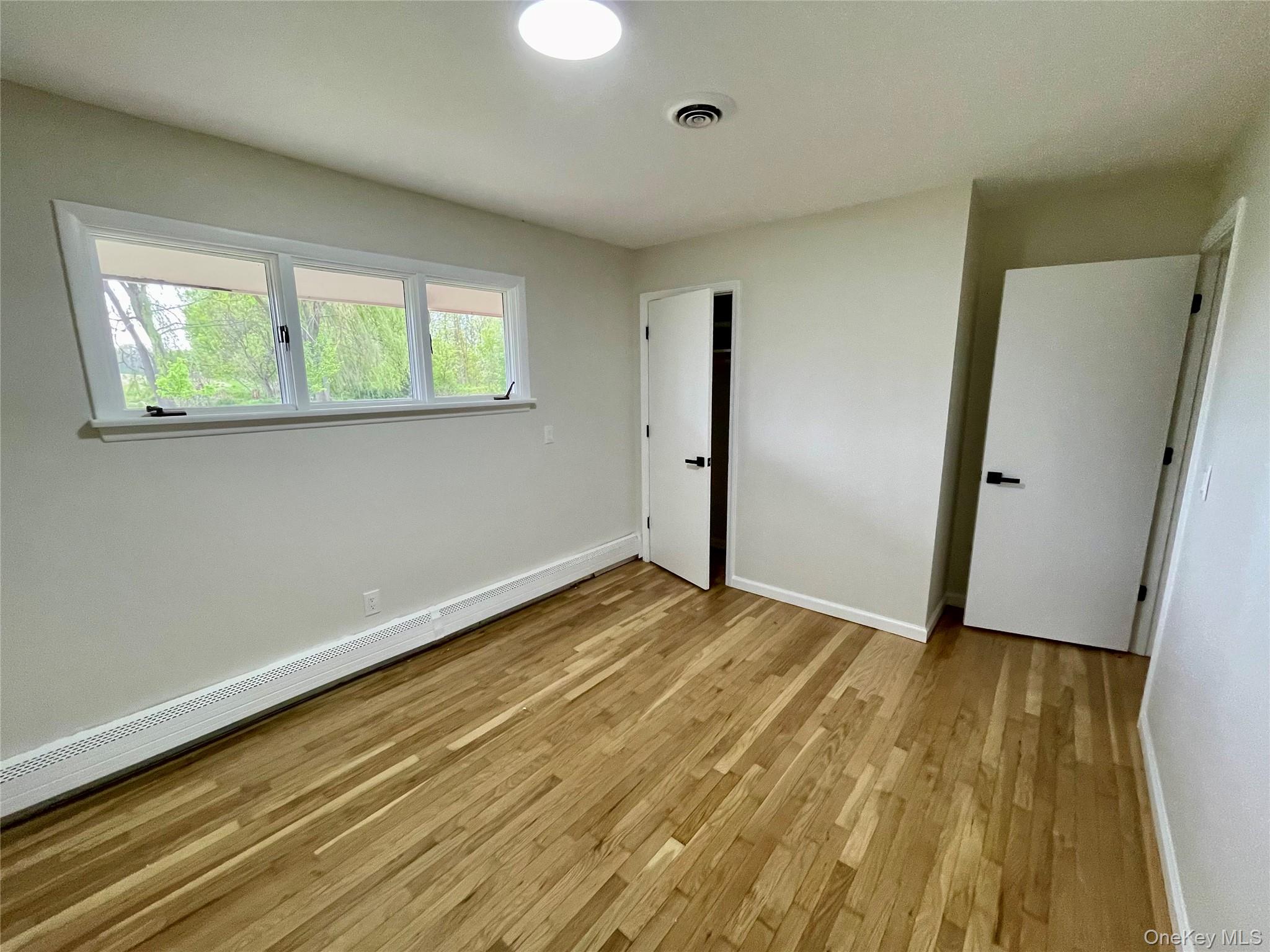 70 County Rte 17 Pine Bush, NY 12566 - Photo 28 of 36 a view of an empty room with wooden floor and a window
