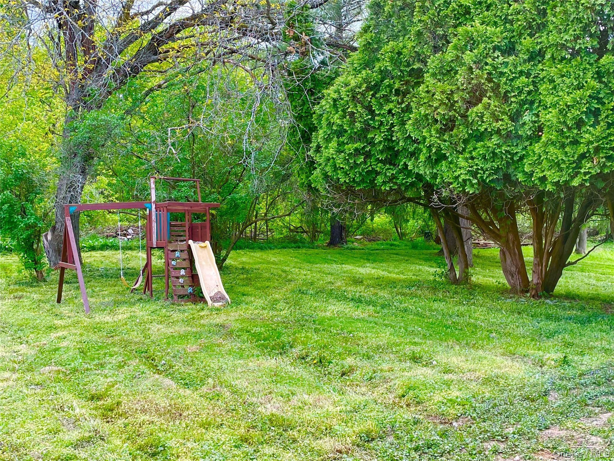 70 County Rte 17 Pine Bush, NY 12566 - Photo 33 of 36 a view of a backyard with a slide and a table