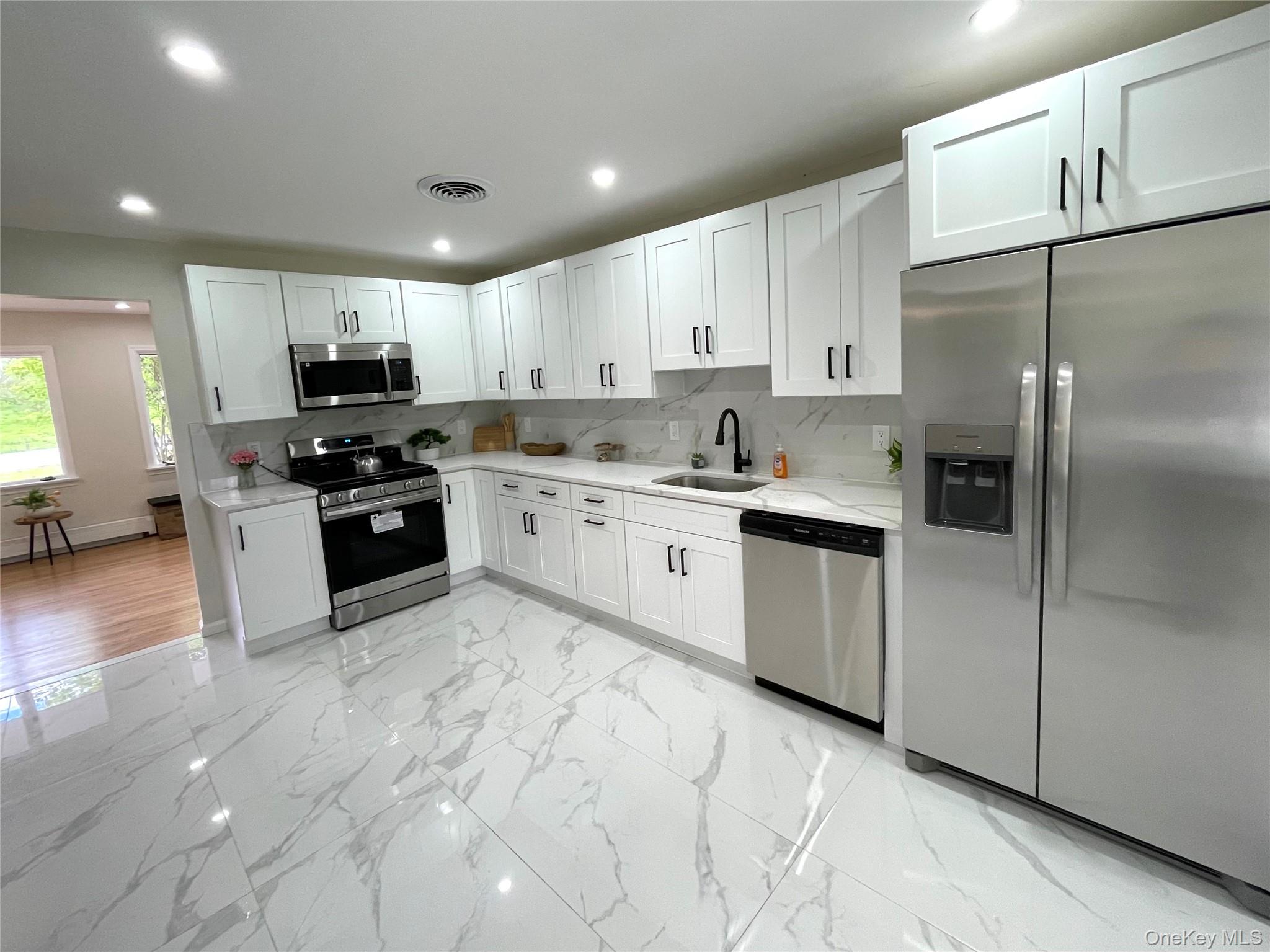 70 County Rte 17 Pine Bush, NY 12566 - Photo 4 of 36 a kitchen with stainless steel appliances granite countertop a refrigerator sink and stove