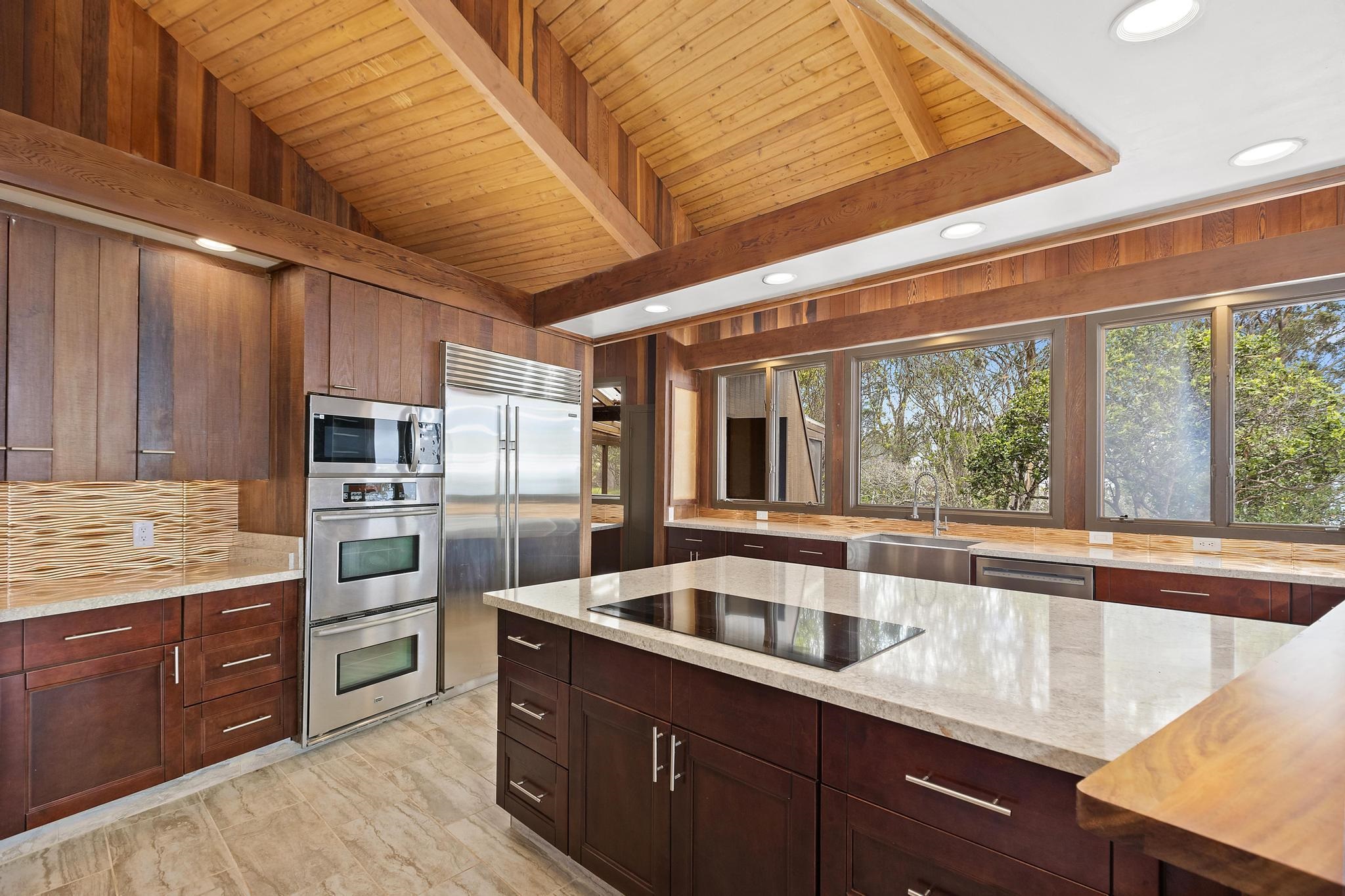 2450 Piiholo Road Makawao, HI 96768 - Photo 4 of 39 a kitchen with stainless steel appliances granite countertop a sink and wooden cabinets