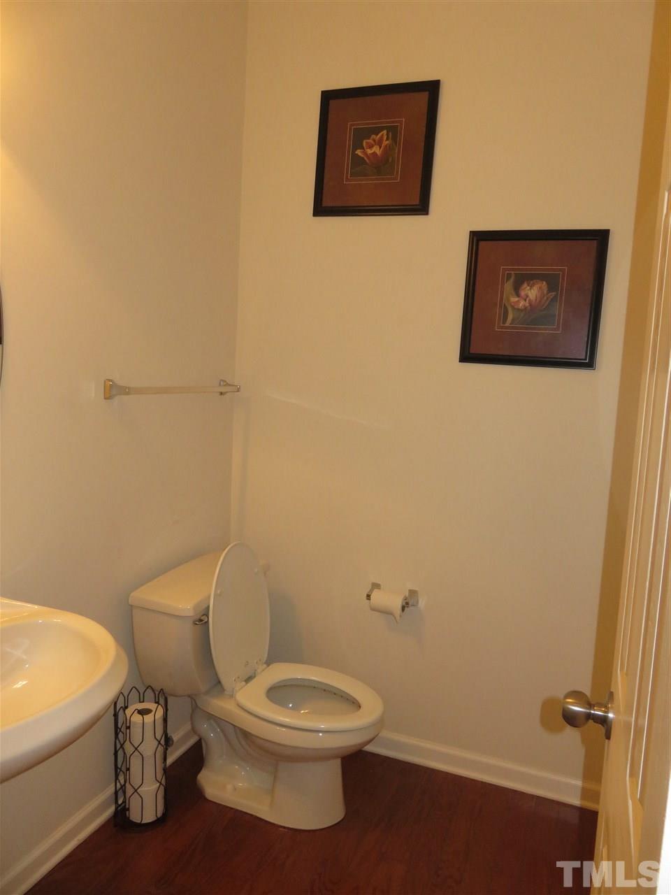 5532 Quitman Trail Raleigh, NC 27610 - Photo 14 of 29 a white toilet sitting next to a white sink and vanity