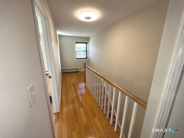 97 Country Hill Road, Unit 97 Naugatuck, CT 06770 - Photo 17 of 31 a view of a hallway with wooden floor and staircase