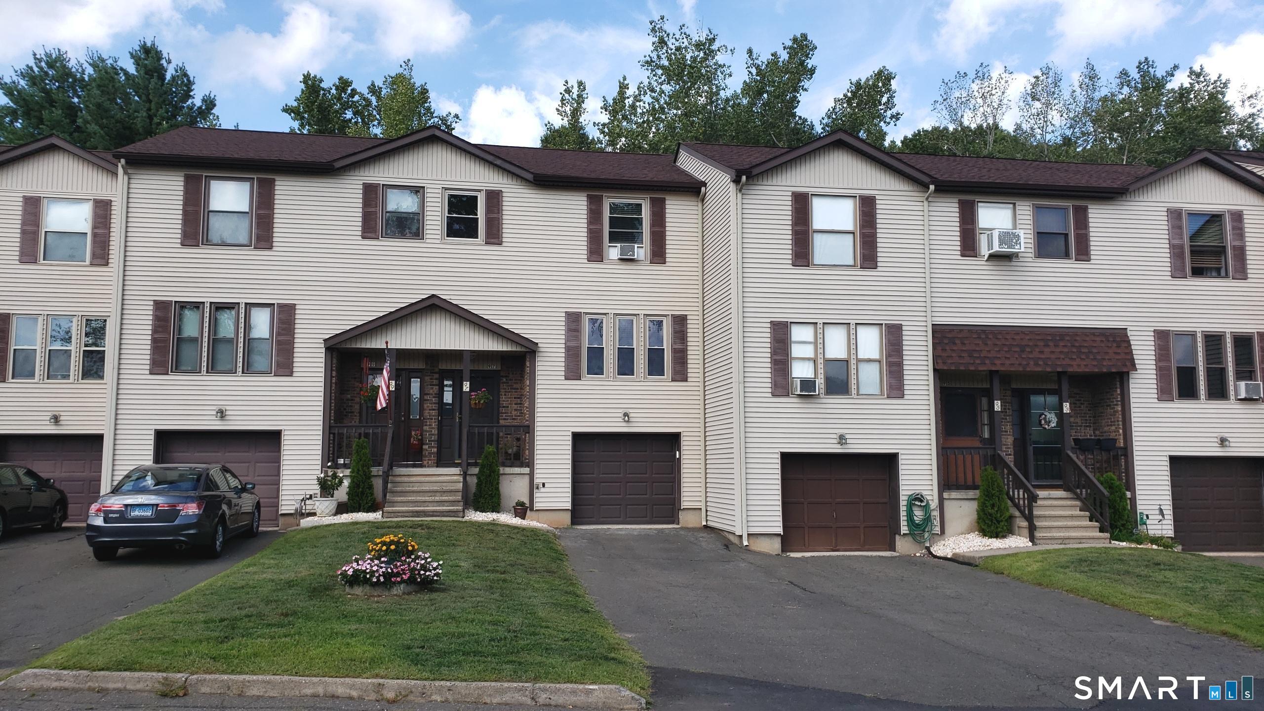 97 Country Hill Road, Unit 97 Naugatuck, CT 06770 - Photo 26 of 31 a front view of a house with a garden and yard