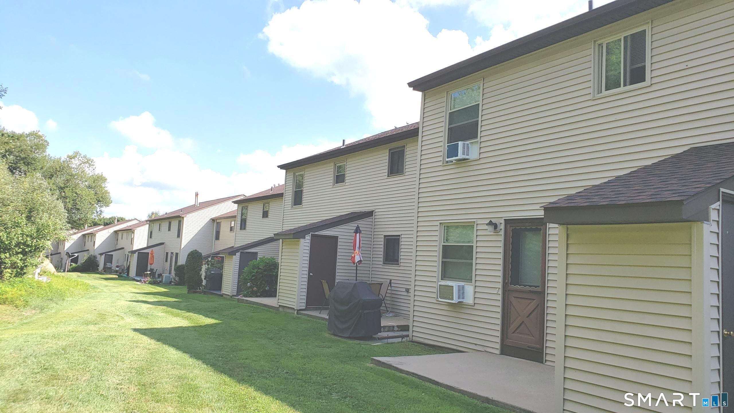 97 Country Hill Road, Unit 97 Naugatuck, CT 06770 - Photo 27 of 31 a view of a house with a yard