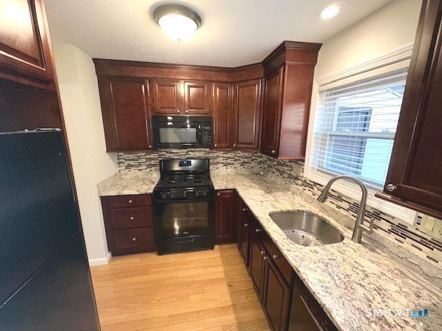 97 Country Hill Road, Unit 97 Naugatuck, CT 06770 - Photo 30 of 31 a kitchen with a stove sink and cabinets