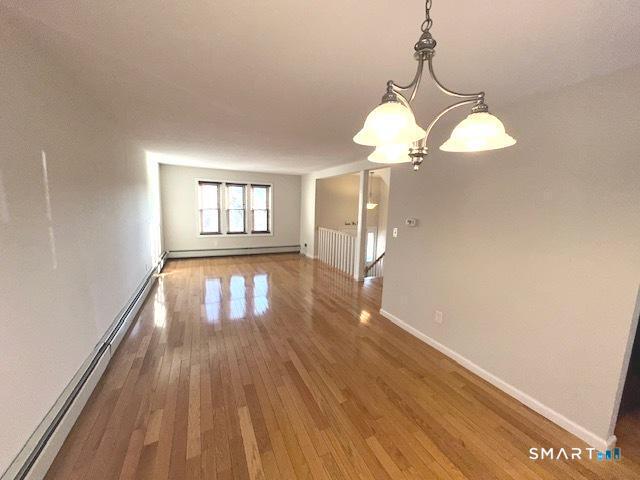 97 Country Hill Road, Unit 97 Naugatuck, CT 06770 - Photo 3 of 31 a view of empty room with wooden floor and fan