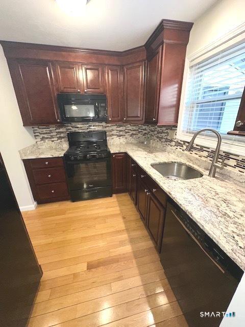 97 Country Hill Road, Unit 97 Naugatuck, CT 06770 - Photo 31 of 31 a large kitchen with kitchen island granite countertop a sink a counter space and a window