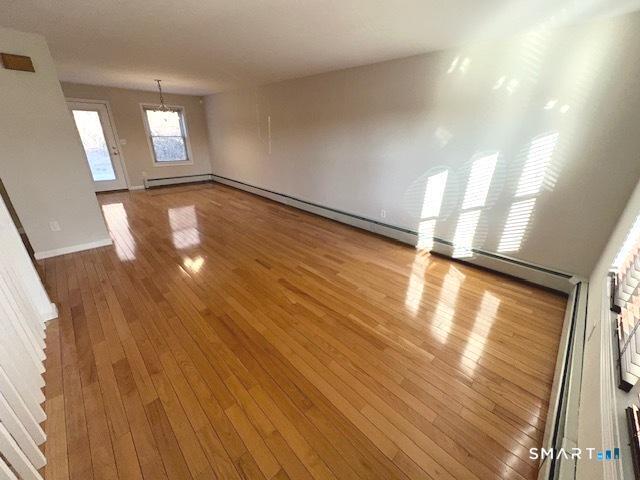 97 Country Hill Road, Unit 97 Naugatuck, CT 06770 - Photo 4 of 31 a view of empty room with wooden floor