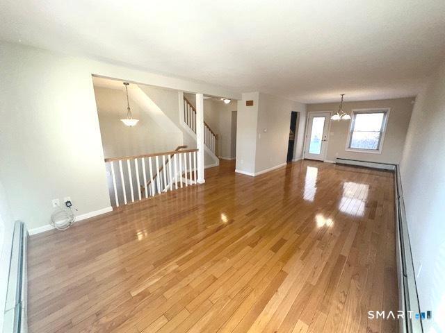 97 Country Hill Road, Unit 97 Naugatuck, CT 06770 - Photo 5 of 31 a view of an empty room with wooden floor and windows