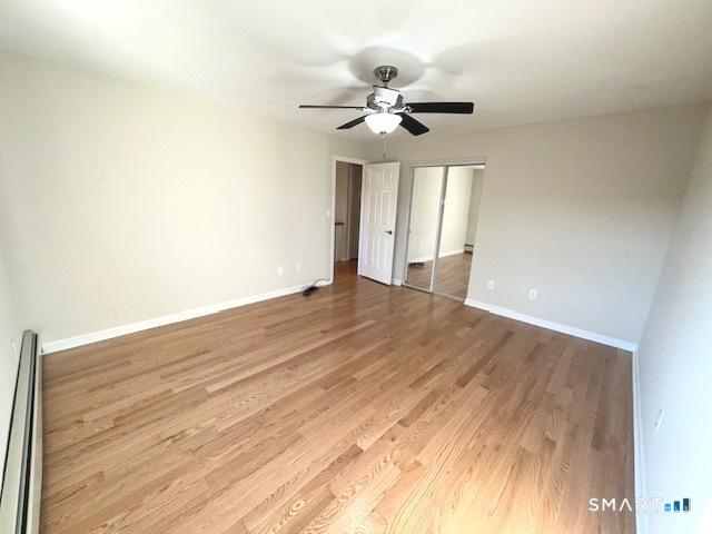 97 Country Hill Road, Unit 97 Naugatuck, CT 06770 - Photo 10 of 31 a view of an empty room with wooden floor and a ceiling fan