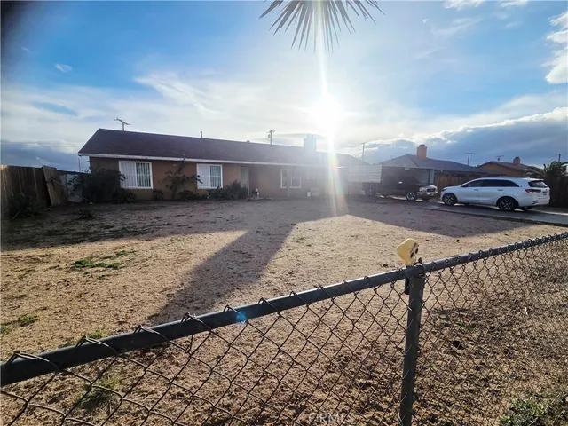 a view of a house with a wooden fence